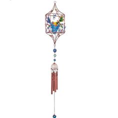 a wind chime hanging from the side of a white wall with blue and green beads