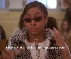 a woman wearing sunglasses and a leopard print jacket with the words honey, it's called being sarcastic