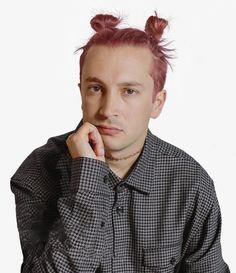 a young man with pink hair wearing a black and white shirt