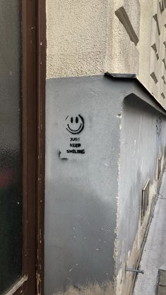 graffiti on the side of a building with a smiley face