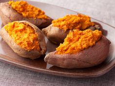 baked sweet potatoes on a plate with the words baked sweet potato written in english and spanish