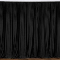 a black curtain is hanging on the wall