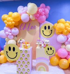 an assortment of balloons and decorations for a child's birthday party with smiley faces