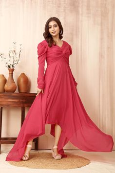 Introducing our Pure Chiffon Pink Gown--a masterpiece of elegance. With its drape top and twisted knot design, long sleeves, and a gracefully flared skirt, this dress is perfect for formal as well as party occasions and exudes timeless sophistication. Make a lasting impression with this regal attire. Fabric: Pure Chiffon Full-length Chiffon Party Dress, Full Length Chiffon Party Dress, Fitted Bodice Chiffon Gown, Festive V-neck Wedding Dress, Pink Chiffon Floor-length Dress, Pink Empire Waist Maxi Dress For Bridesmaid, Pink Maxi Evening Dress For Wedding Guest, Pink Maxi Length Evening Dress For Wedding Guest, V-neck Gown For Wedding Guest