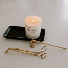 a candle and scissors on a tray