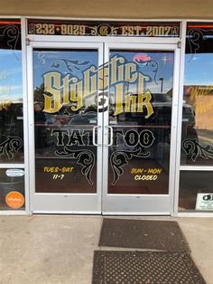 the front door of a tattoo parlor with large glass doors that say, gothic ink