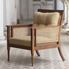 a wooden chair sitting on top of a tiled floor