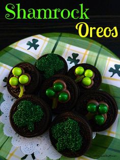 there are chocolates with green toppings on a plate that says shamrock oreos