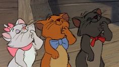 three cartoon cats standing next to each other