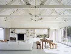 a living room filled with furniture and a fire place in the middle of it's walls