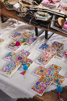 many colorful cards are laid out on a table with other crafting supplies in the background