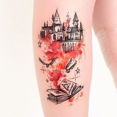 a tattoo with hogwart's castle and harry potters book on the thigh