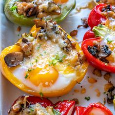 stuffed bell peppers with mushrooms and other toppings on a white tray, ready to be eaten