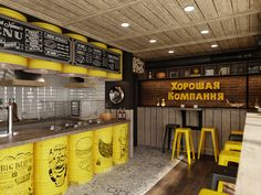 the interior of a restaurant with yellow stools