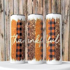 three personalized tumbles with the words thank fall on them