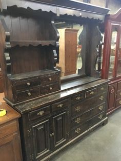 an old wooden dresser and mirror in a store