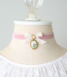 This charming coquette choker necklace is handmade with a soft double sided blush pink velvet ribbon. It features a vintage lace ribbon bow, pearl bead jewel and a beautiful vintage floral cameo with a sweet pink rose. A lovely gift for women who love to wear romantic Regency and Victorian fashion jewelry.  See last photos for coordinating designs available separately in the Rosy Posy Designs shop... a fun group gift for mothers, daughters, sisters and friends! * Size ~ Adjustable length 12 - 15 Vintage Ribbon Choker As A Gift, Vintage Ribbon Choker As Gift, Elegant Pink Choker As Gift, Elegant Pink Choker For Gift, Pink Ribbon Wedding Jewelry, Delicate Pink Choker For Gift, Feminine Adjustable Ribbon Jewelry, Pink Vintage Choker Jewelry, Fantasy Country