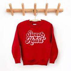 Looking for a cute sweatshirt for your kids? We have the perfect Sweet Heart With Heart graphic sweatshirt addition to their closet! Also available in toddler sweatshirts. Playful Red Cotton Sweatshirt, Sweet Red Crew Neck Top, Playful Red Sweatshirt For Fall, Red Long Sleeve Sweatshirt For Valentine's Day, Cute Red Crew Neck Sweater, Cute Red Long Sleeve Sweatshirt, Cute Sweatshirt With Heart Graphic And Crew Neck, Cute Crew Neck Sweatshirt With Heart Graphic, Cute Red Crew Neck Sweatshirt