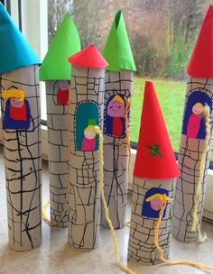 some very cute looking little castle made out of toilet paper rolls and yarn on the windowsill