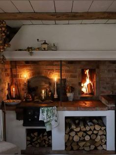 a fireplace with logs stacked on top of it