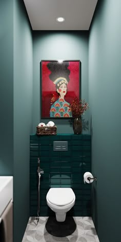 a bathroom with green walls and a painting on the wall