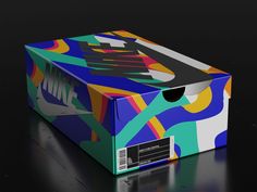 a colorful box is open on a black surface