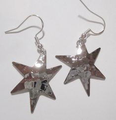 Beautiful, shiny, silver-plated stars!   These silver plated (treated to deter tarnish) earrings are approximately 1 1/4  inch in size and the back of these earrings are plain.  All earrings have sterling silver (.925) fishhook fasteners and all fishhooks come with a clear, rubber earring back. Silver Star Earrings, Hammered Silver, Shiny Silver, Silver Stars, Star Earrings, Earring Backs, Halloween Shopping, Silver 925, Jewelry Earrings Dangle