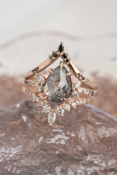 a close up of a diamond ring on top of a piece of glass with ice