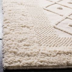 a white rug with an intricate design on it