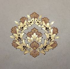 an ornate gold and brown design on a gray background