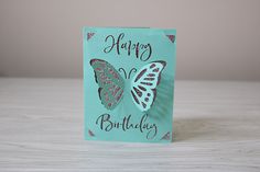 a blue birthday card with two butterflies on the front and one butterfly on the back