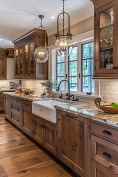 a kitchen filled with lots of wooden cabinets and counter top space next to a window