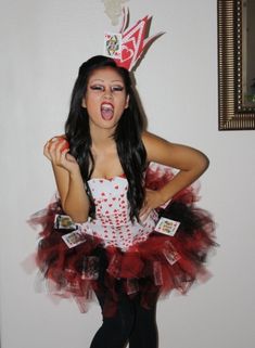 a woman wearing a red and white dress with a crown on top of her head