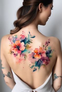 the back of a woman's body with flowers painted on her shoulder and chest