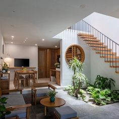 a living room filled with furniture next to a staircase