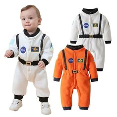 two baby onesuits with nasa patches on them and one is wearing an orange astronaut suit