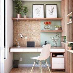 a room with a desk, shelves and pictures on the wall next to a window