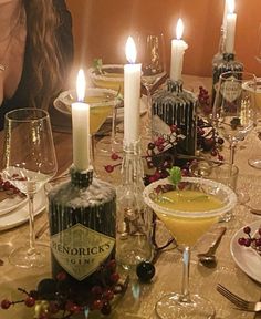 a table is set with wine glasses and candles