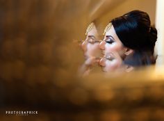 a bride and her reflection in the mirror