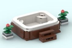 there is a lego hot tub and two planters on the ground next to it