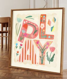 an art work with flowers and the letter d in it's frame on a wooden floor