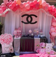 a chanel themed birthday party with pink and white balloons