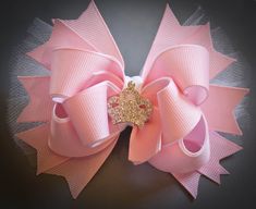 "Pink Princess Bow with a nice rhinestone crown centerpiece. Measures approximately 4 3/4\" across and comes secured to a partially lined, double pronged hair clip with a no slip grippie attached to help keep it snug in the hair.   All our bows are well starched and ribbon is heat sealed for added durability. All our bow sets are attached to beautiful bow cards and wrapped in matching tissue paper.   All items are shipped in sturdy mailing boxes to ensure they stay perfect during their travels t Pink And Gold Hair, Life Script, Crown Centerpiece, Bow Cards, Birthday Hair Bow, Gold Hair Bow, Princess Hair Bows, Stacked Hair Bow, Princess Hair