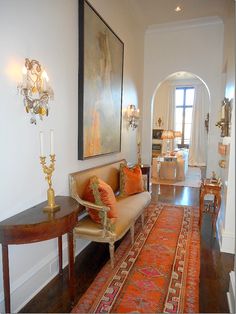 a living room filled with furniture next to a doorway