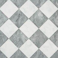 a white and grey tiled floor with diamond shaped tiles on the top, diagonally