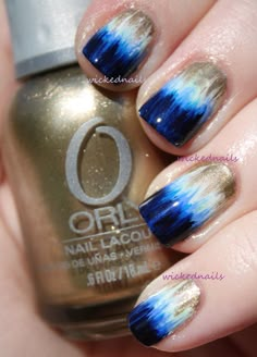 blue and gold nail polish with white tips on the tip, two tone nails are accented with metallic flecks