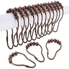 a bunch of brown beads are hanging on a white curtain with some cords attached to it