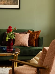 a living room filled with furniture and a flower vase on top of a coffee table