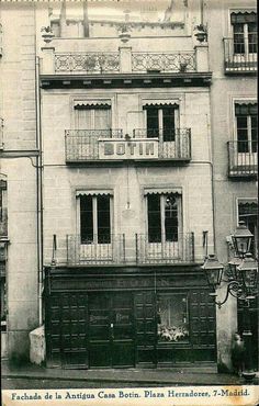 an old building with balconies on the second floor