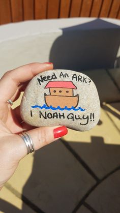 a hand holding a rock that says need an ark? i noah guy on it